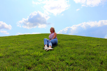 Naklejka na ściany i meble person sitting on the grass