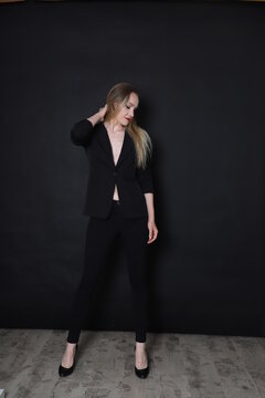 Photo of a fashion girl on a black background in black clothes light skin