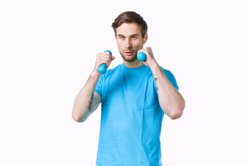Fototapeta premium sports man with dumbbells in hands workout fitness light background