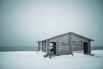 House by the sea, winter landscape along the Arctic Ocean.