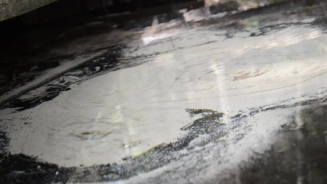 Abstract view of drinkable erupting fresh water source in nature. Natural crystal clear water comes from underground and makes the sand boil. Boiling sand pure water stream in nature