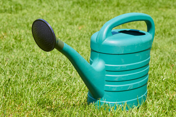 watering can on the lawn,garden tool for watering flowers in the garden