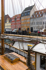 Fototapeta na wymiar Famous Nyhavn Canal in winter with ships in the foreground and colored house in background