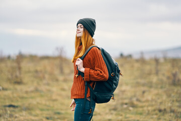 woman hiker with backpack in the mountains fresh air travel nature
