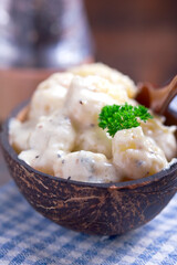 gnocchi in coconut sauce, served in a coconut bowl