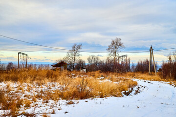 Photography of russian railway in the winter or early autumn day with snow. Snowy landscape
