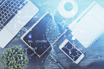 Double exposure of DNA drawing over table with phone. Top view. Science education concept.