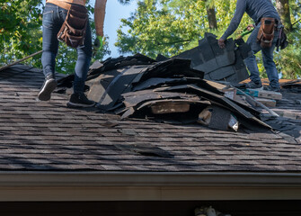 Roofers removing old material from a house in preparation for storm damage repair.  © colorburst100