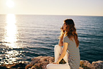 Fototapeta na wymiar beautiful woman near the sea at sunset summer t-shirt sky