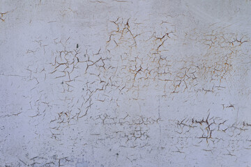 Painted in white old cracked metal rusted background. Metal rust texture. Erosion metal. Scratched and dirty texture on outdoor rusted metal wall.