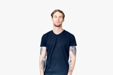 Fototapeta premium portrait of a handsome man in a blue t-shirt close-up model tattoo