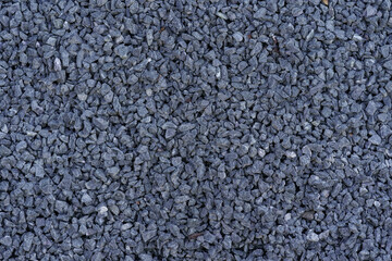 Gray small rocks ground texture. Dark gray small road stone background. Gravel pebbles stone seamless texture.