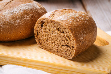 Closeup on loafs s of wheat bread on the wooden table