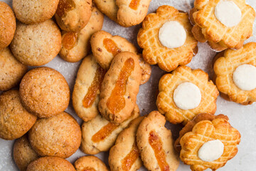 Heap of different small cookies on the grey background
