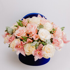 Round royal blue velvet box with white roses and pink alstroemeria and cymbidium.