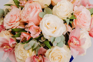 Round royal blue velvet box with white roses and pink alstroemeria and cymbidium.