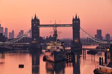 Naklejka premium View of Tower Bridge against skyscrapers. Urban skyline of London at morning light, United Kingdom..
