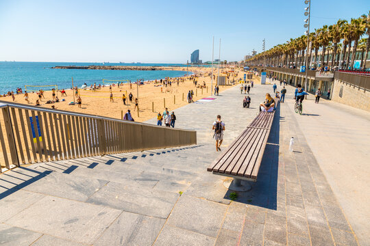 Beautiful picture of Barcelona beach plenty of people enjoying  the sun and summer playing beach sports.