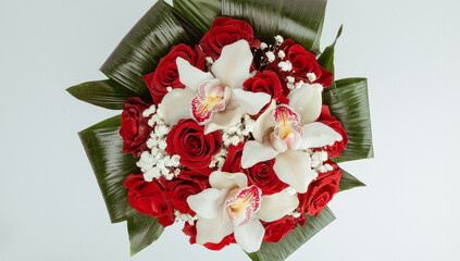 Bouquet Red roses with cymbidium gypsophila and aspidistra at the base.