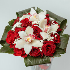 Bouquet Red roses with cymbidium gypsophila and aspidistra at the base.