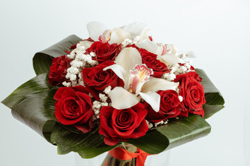 Bouquet Red roses with cymbidium gypsophila and aspidistra at the base.