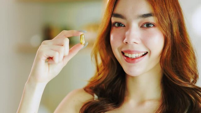 Beauty asian  Pregnant woman  holding vitamin pill isolated at home.healthcare and medical concept.