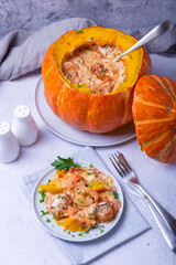 Pumpkin stuffed with shrimps and cheese, whole baked. Traditional Brazilian dish. Close-up.