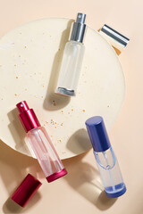 colorful glass package perfume on beige background