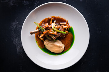 Roasted lamb chops with chanterelles and vegetables on decorated table