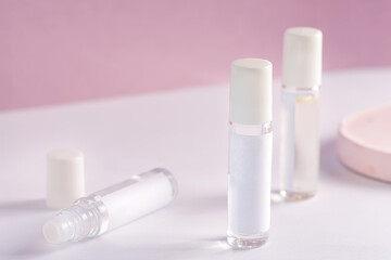 glass product package perfume samples on pink background