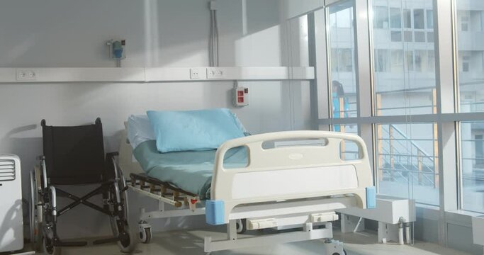 Empty bed and wheelchair n modern hospital room