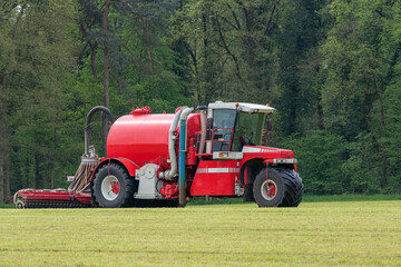 Naklejka premium Injecting a freshly mowed lawn with a red injector .