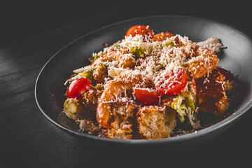 Seafood Caesar Salad with Shrimps, Salad Leaf, Croutons, Cherry Tomato and Parmesan Cheese in bowl