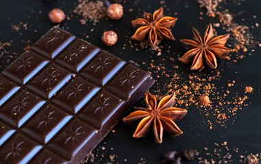 Chocolate bar with spice anise, chocolate flakes and powder