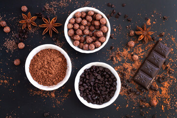 Chocolate bar pieces with ingredients for cooking sweet food top view