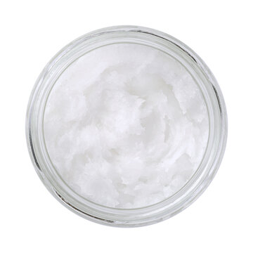 Coconut oil in a glass jar. Unrefined coconut butter, an edible oil, derived from the wick, meat, and milk of the coconut palm fruit. White solid fat, melting at warmer room temperatures. Food photo.