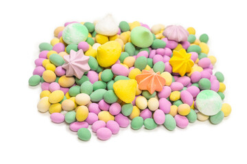 Colorful meringues and glazed peanuts isolated on a white background.
