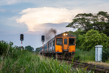 Diesel train for transporting passengers that countryside in Thailand in the evening.