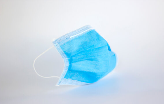 High density blue color 3 ply non-woven disposable surgical masks with elastic hoop ears isolated on a white background