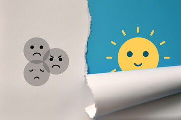 Drawings of sad faces on one side and a happy face on the other side. The choice of joy or sadness...