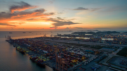 Aerial view of sunset sky at international cargo sea port.