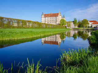 Fototapeta na wymiar Güstrow Castle with a pond in Mecklenburg-Western Pomerania