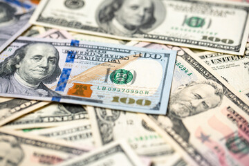 Closeup of one hundred dollar banknotes, new and old paper bills from USA. American cash and money piled up