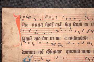 A medieval manuscript hand written onto parchment or vellum and illuminated with red initial...