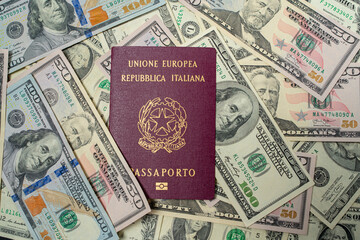 Italian Passport on top of dollar banknotes. One hundred and fifty USD bills. European Union...