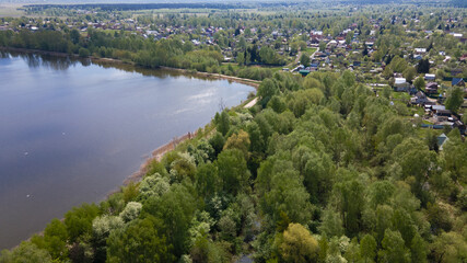 Panoramic view of the countryside and the lake from a bird's eye view. Drone photos, aerial photography.