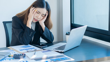 Business women have a headache while sitting in the office