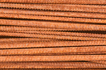 background - pieces of rusty rebar piled in a heap close-up