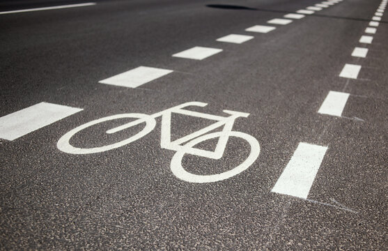white bicycle sign on a bike lane