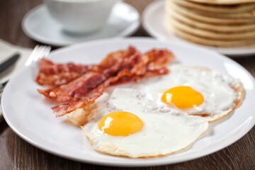 Fried Eggs with Pancakes and Bacon. High quality photo.